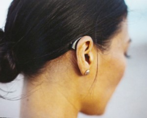 Lady wearing behind the ear hearing aid